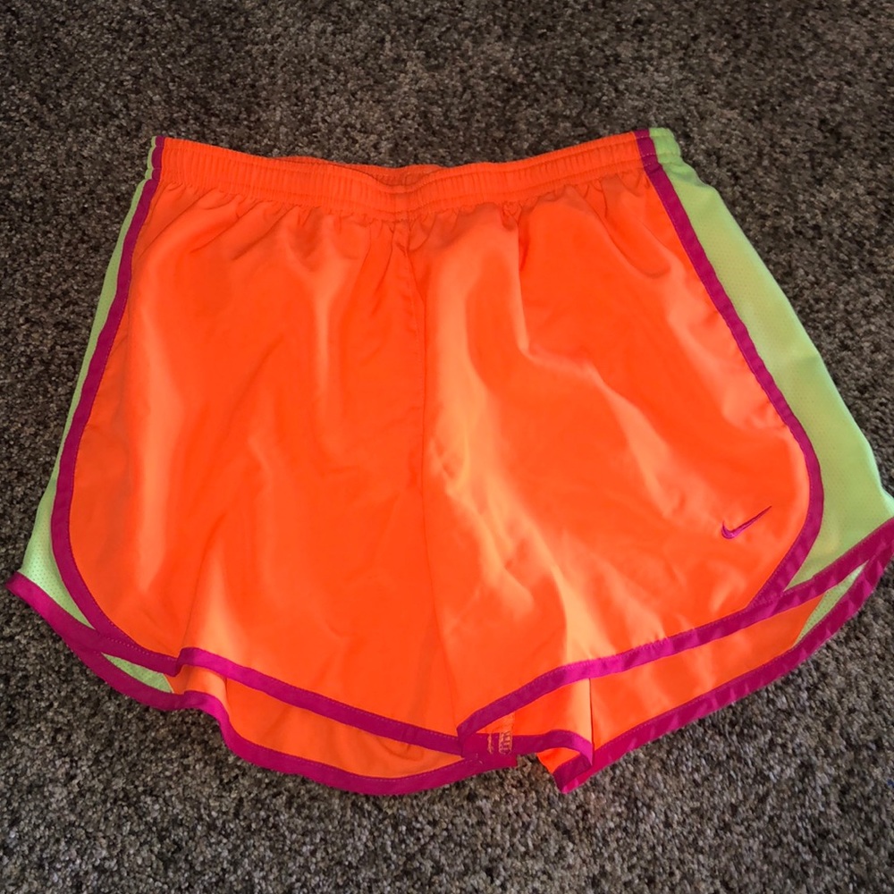 Neon orange Nike athletic shorts.